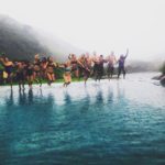 students on a Spanish immersion trip with CGI take a photo jumping into a pool